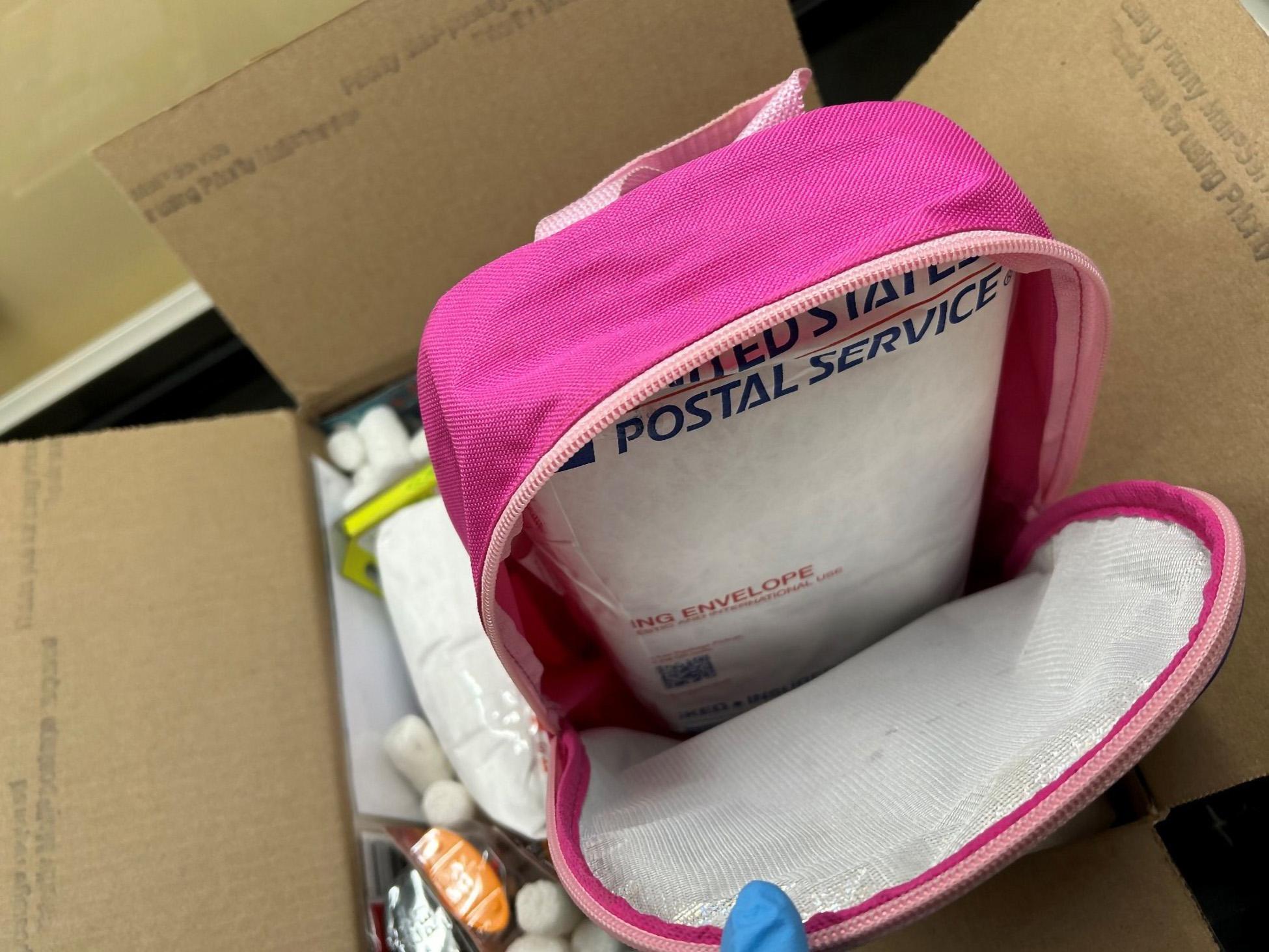 Pink bag with mail parcel inside.