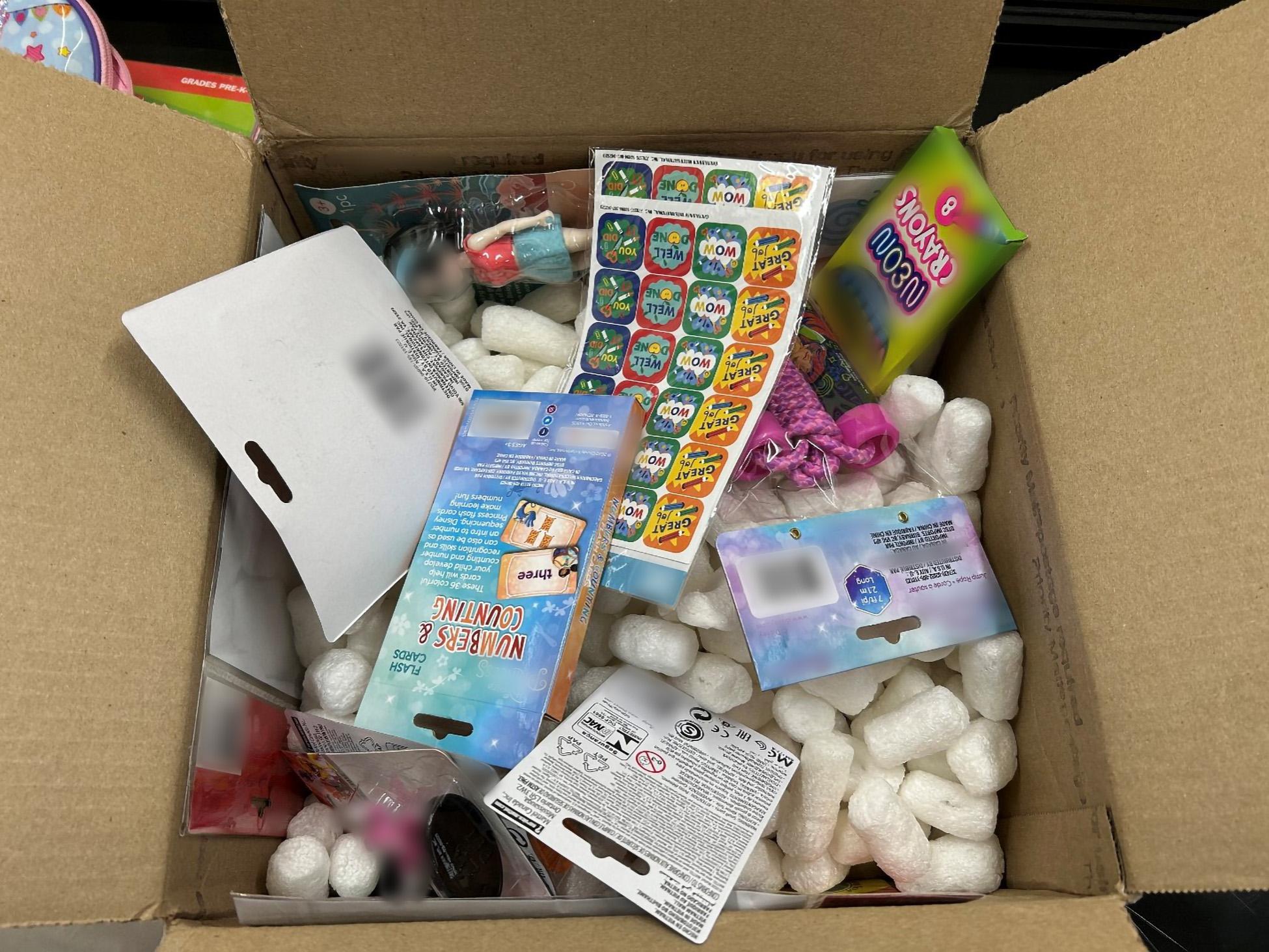 Open box with children's merchandise.