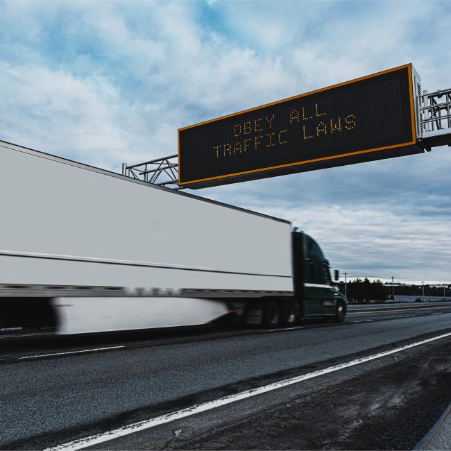 Photo of tractor trailer driving. 